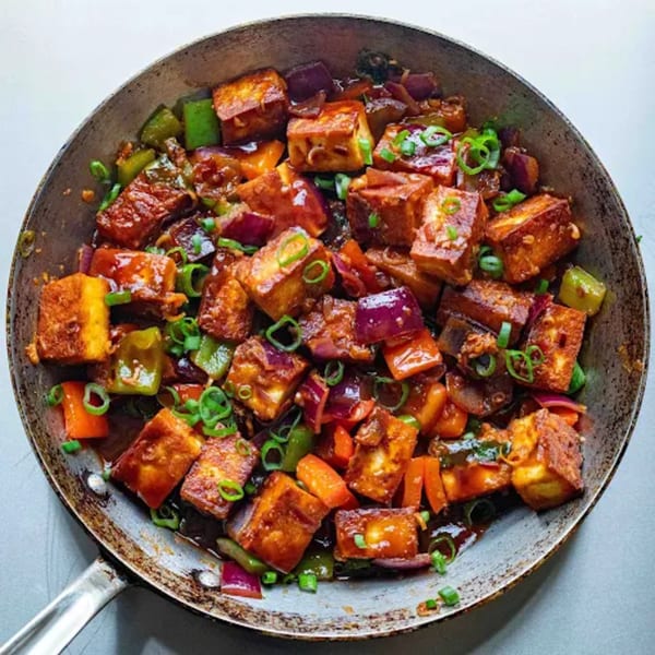 Chilli Paneer, a popular Indian dish, with paneer, bell peppers, and onions in a rich sauce.